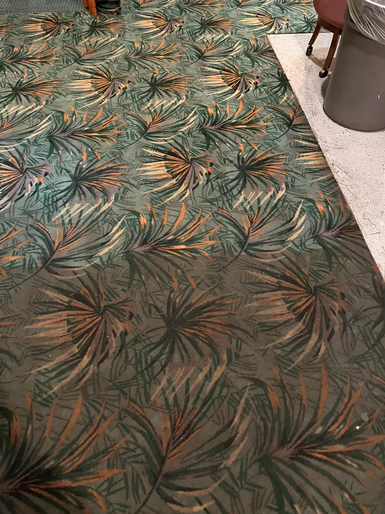 Freshly cleaned green carpet with a palm leaf pattern